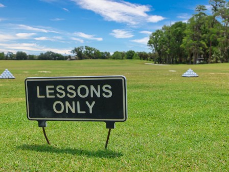A sign on a golf course reads 